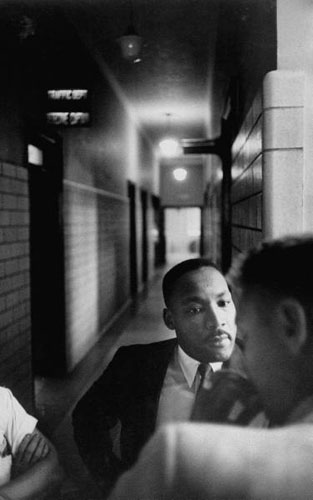 Martin Luther King in hallway as he learns his fine has been paid, Montgomery, Alabama Police Headquarters, 1958