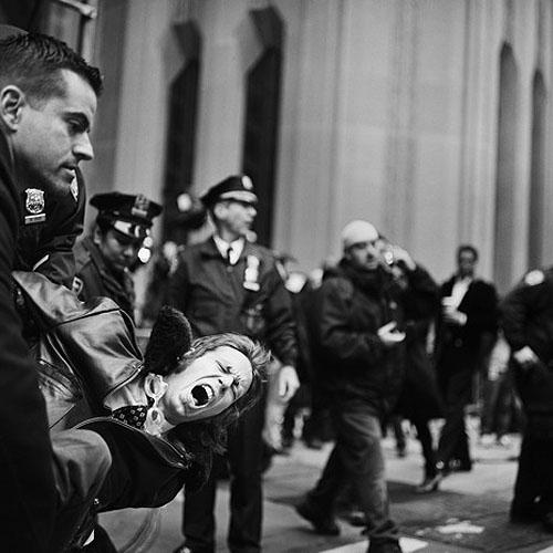 An Occupy Wall Street demonstrator is arrested on Broadway and Wall Street on November 17, 2011<br/>