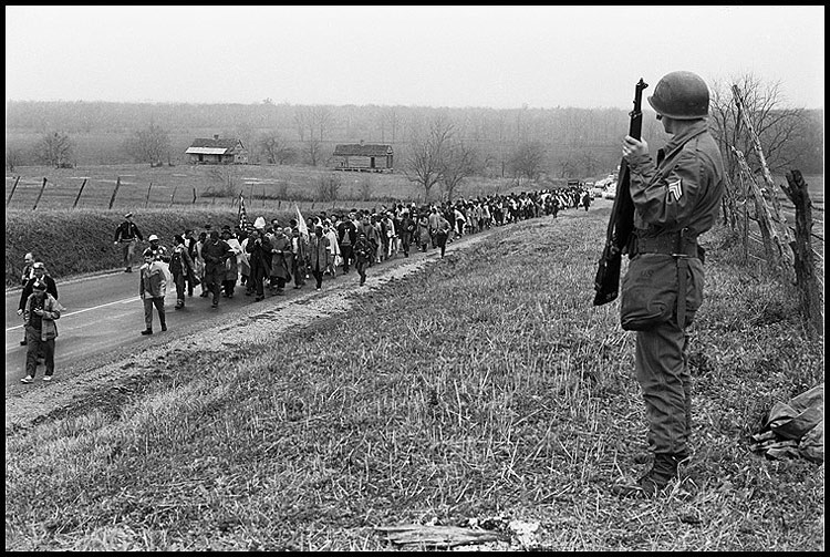 Marching up Highway 80 under the protection of the US army Sharpshooters