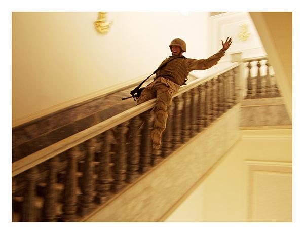 Photo: A marine slides down the marble handrail in Saddam's palace in Tikrit Archival Pigment Print #2182
