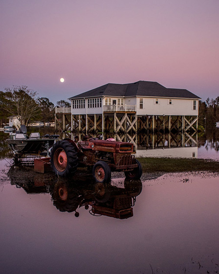 A home on narrowly escapes the flood as the sun sets in Rocky Point, 2018