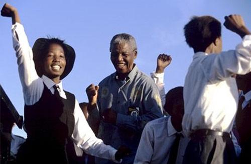 Nelson Mandela dances with schoolchildren at a campaign event, 1994<br/>