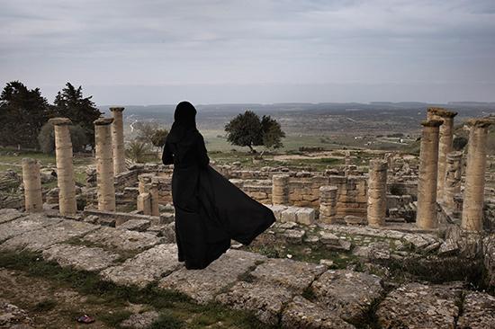Photo: Shehat, Libya March 25, 2012 A Libyan woman visits the ruins of the ancient city of Cyrene in eastern Libya's Green Mountains Archival Pigment Print #2335