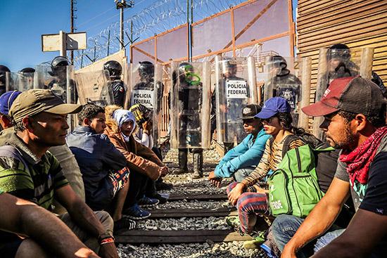 Photo: Asylum seekers from the Central American exodus being prevented from making claims by Mexican Federal Police, Tijuana, Mexico, November 25, 2018 Archival Pigment Print #2339