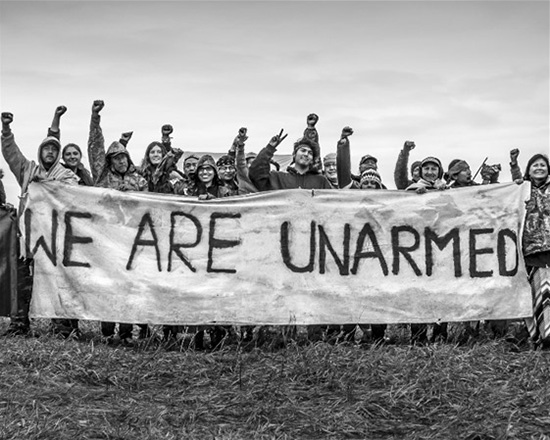 A banner that was hung at Oceti Sakowin Camp to remind law enforcement the camp was non-violent and was also carried during actions and marches through North Dakota during the Standing Rock movement, September 21, 2017