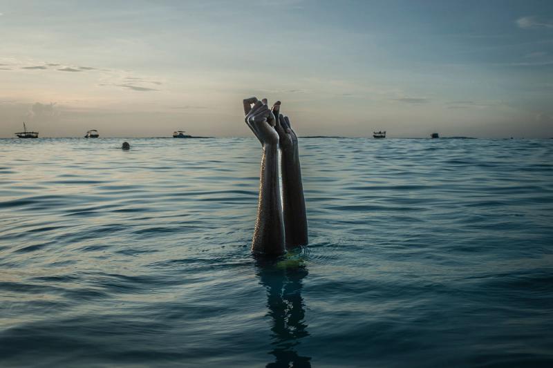 Anna Boyiazis Swim instructor Chema, 17, snaps her fingers as she disappears underwater in Nungwi, Zanzibar, 2016<br/>