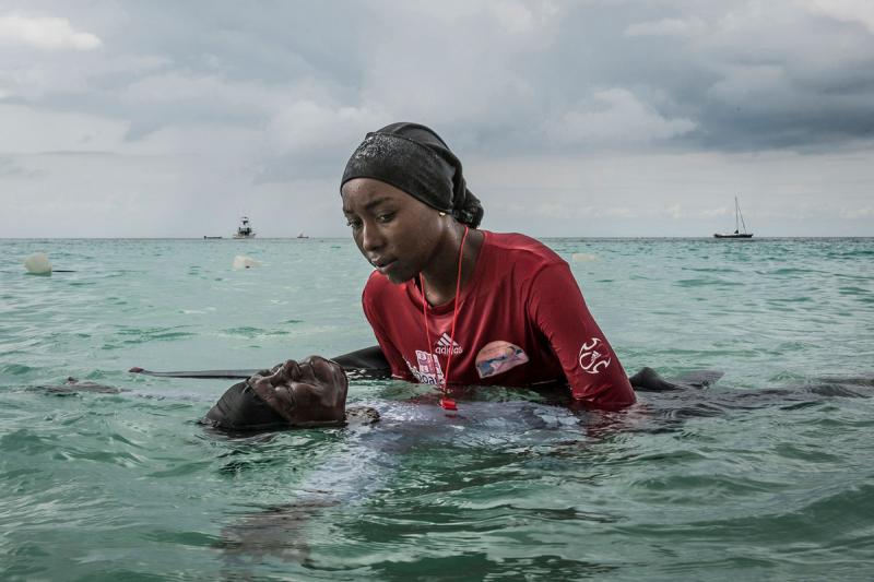Swim instructor Siti, 24, helps a girl float in the Indian Ocean off of Nungwi, Zanzibar, 2016<br/>