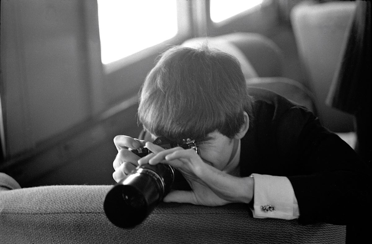 George Harrison photographing, NY, 1964