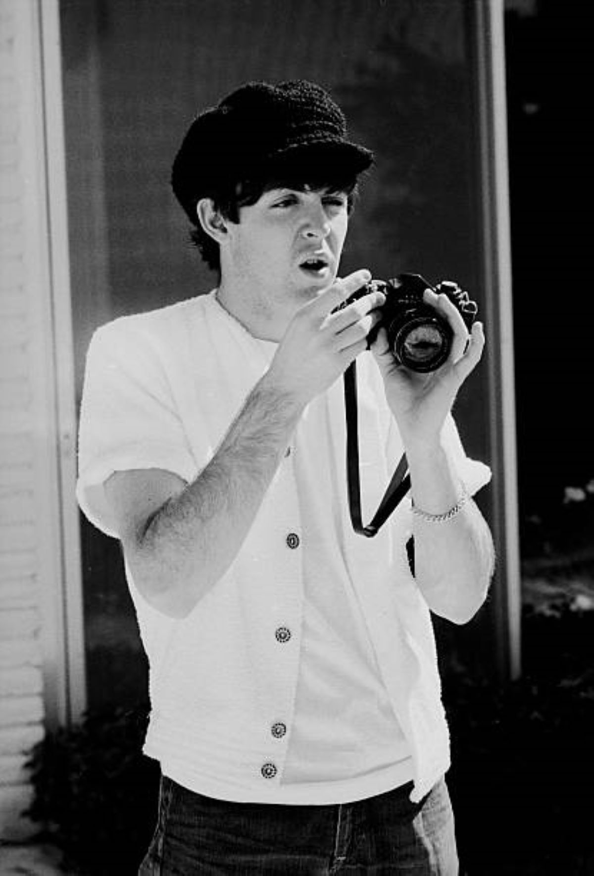 Paul McCartney of the Beatles holds a camera as he prepares to photograph, Miami Beach, Florida, February 1964