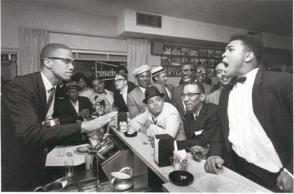 Malcolm X and Muhammad Ali in an animated discussion, Miami, 1964