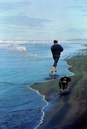Presidential candidate Bobby Kennedy and his dog, Freckles, running on an Oregon beach, 1968 (cover of Life Magazine, June 14, 1968)<br/>