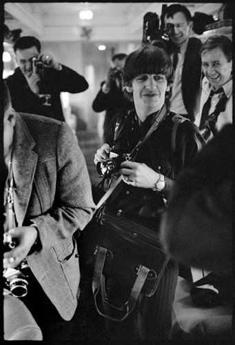 Ringo with Press Photographer's Gear. Train to D.C. Feb 10, 1964.  Copyright Bill Eppridge
