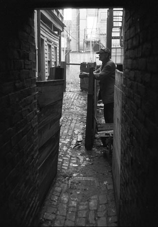 Man in alley, Wilmington, DE, early 1950's