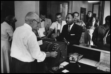 Martin Luther King at Police Headquarters, as he argued to  reject bail and  serve his sentence for disturbing the peace in Montgomery, Alabama, 1958
