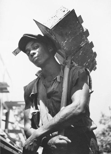 Brick carrier at model community planned by the Suburban Division of the U.S. Resettlement Administration, Greenbelt, Maryland, 1936 (for the Farm Security Administration) (Time Inc.)