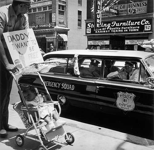 William Edwin Jones pushes daughter Renee Andrewnetta Jones (8 months old) during protest march on Main St., Memphis, TN (The little girl grew up to become a doctor) August, 1961
