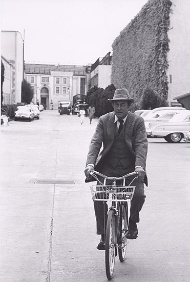 Rex Harrison on bike going to set of "Mt Fair Lady", 1963