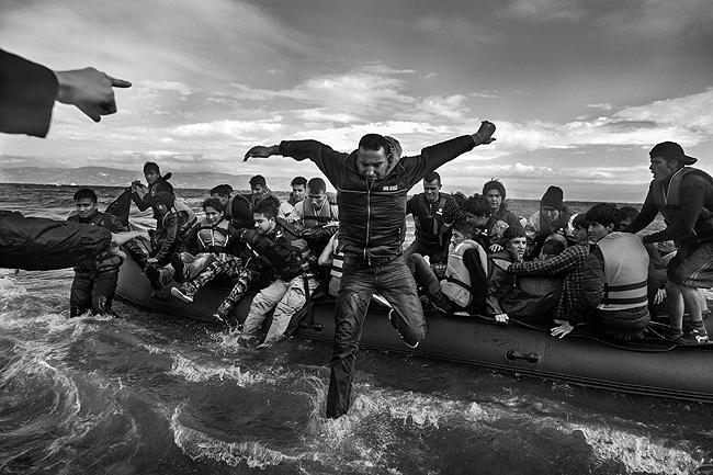 Refugees, primarily from Syria, Iraq and Afghanistan, disembark on the island of Lesvos, Greece, 2015<br/>