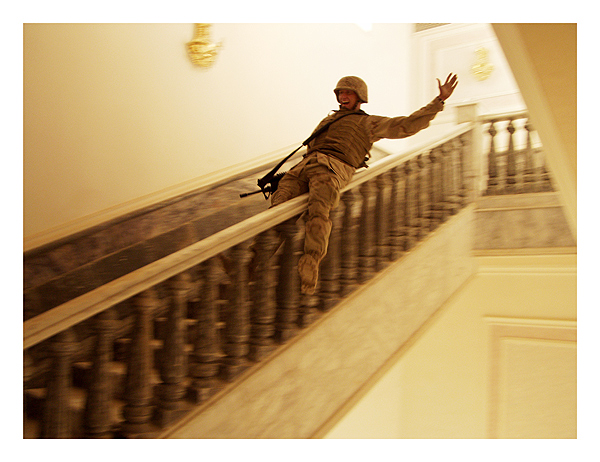 A marine slides down the marble handrail in Saddam's palace in Tikrit