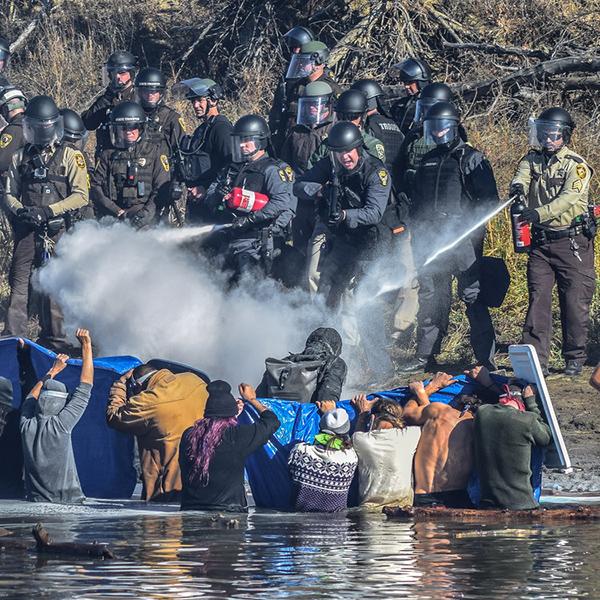 Photo: Native American Water Protectors attempt to gain access to Turtle Hill, where many of their ancestors are buried, to pray, 2016. Archival Pigment Print #2189