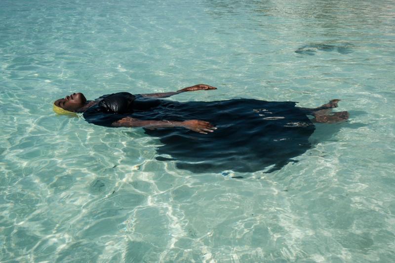 A young woman learns to float in the Indian Ocean off of Nungwi, Zanzibar, 2016 Archival Pigment Print