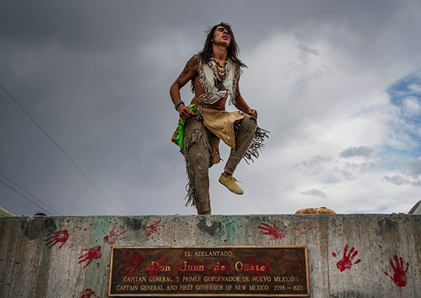 Than Tsídéh, 19, of the Ohkay Owingeh Pueblo dances on the empty platform where a statue of Juan de Oñate was removed,  Rio Arriba county, New Mexico, June, 2020