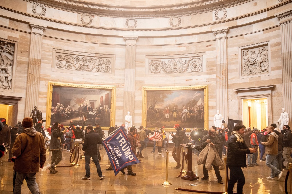A mixture of tear gas discharged by police and fire-extinguisher residue discharged by pro-Trump extremists hung in the air of the Rotunda as the crowd milled about, 238 p.m., January 6, 2021