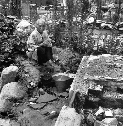 A woman draws water in the midst of rubble, two years after the bombing of Hiroshima Gelatin Silver print