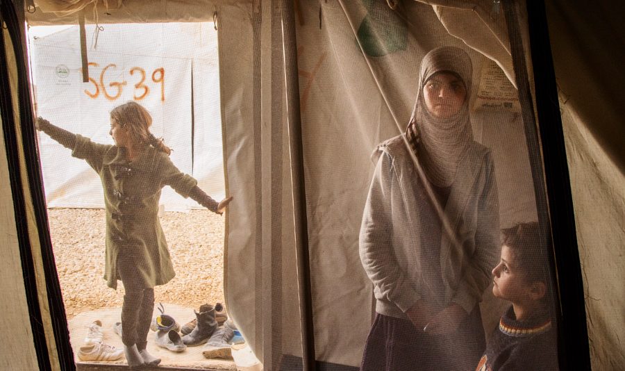 A young girls spends time with her her siblings in her family tent at the Al Za’atri refugee camp near Mafraq, Jordan, 2013. With nearly 200,000 people, Al Za’atri is now the second largest refugee camp in the world.