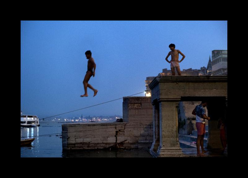 Photo: Kids jump off a ghat into the Ganges River in Varanasi, India. 2019 Archival Pigment Print #2573