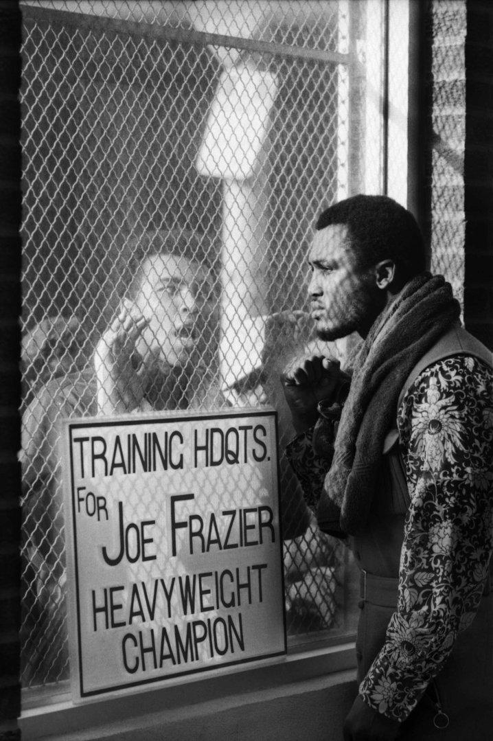 Boxer Muhammad Ali taunting Joe Frazier at Frazier's training headquarters, 1971 by John Shearer. Gelatin Silver print
