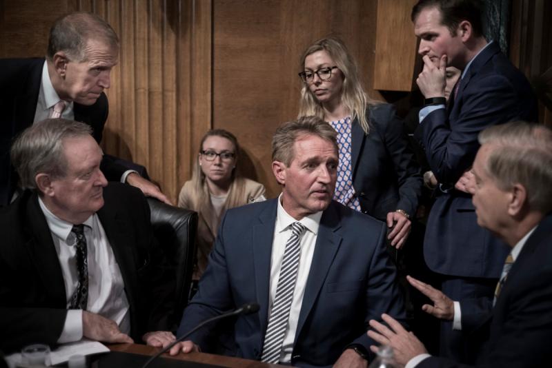 September 28, 2018. Arizona Senator Jeff Flake is surrounded by fellow Republicans Senatos. Thom Tillis (R-NC) above left, Mike Crapo (R-ID) and Lindsey Graham (R-SC), lower right. Flake had just appealed for a delay on Brett Kavanaugh's confirmation vote Archival Pigment Print