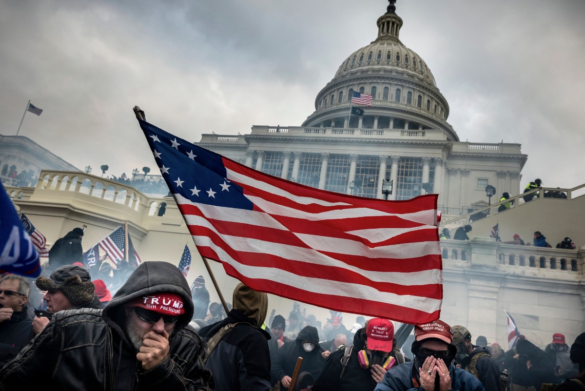 January 6, 2021. Supporters of President Donald Trump retreat from tear gas during a battle with Law Enforcement  officers on the west steps of the Capitol in Washington during the attack on the day of Joe Biden’s election certification by Congress