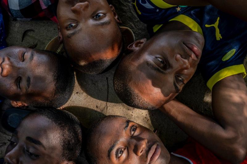 Obama Mchembe lying in the shade of cassia trees with his schoolmates Roger Muhud, 15; Islam Omari Mbena, 15; Omari Rashidi Mcharaga, 17; and Johnson Pascal, 15. Mwandege, Tanzania, 2024.<br/>Please contact Gallery for price