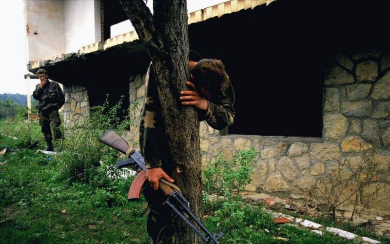 Photo: Senad Medanovic, sole survivor of a massacre at his home after a battle. He is standing on  what is believed to be a mass grave of 69 people, including members of his own family. Bosnia  1995 Archival Pigment Print #2951