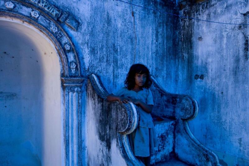 Photo: A displaced Muslim girl takes up shelter at a destroyed mosque after fleeing a government  offensive against the Tamil Tigers. Nanathan, Sri Lanka 2007 Archival Pigment Print #2954