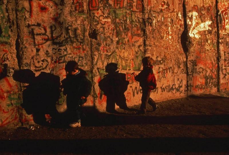 Photo: German children run alongside the Berlin wall as the wall came down and reunified East and West Germany. 1989 Archival Pigment Print #2958
