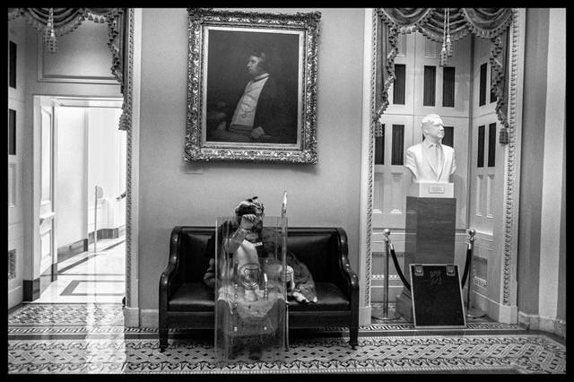 Photo: A Trump supporter inside the US Capitol with a police shield stopped for a rest during the  melee, next to a bust of Richard Nixon. Washington, DC January 6, 2021  Archival Pigment Print #2966