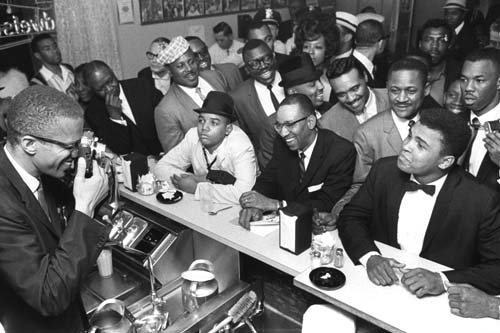 Black Muslim leader Malcolm X photographing Cassius Clay, Miami, 1964, by Bob Gomel