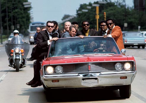 Bobby Kennedy campaigns in IN during May of 1968, with various aides and friends:  former prizefighter Tony Zale and (right of Kennedy) N.F.L. stars Lamar Lundy, Rosey Grier, and Deacon Jones