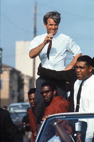 The Kennedy campaign travels through the Watts section of Los Angeles on the last day before the primary, 1968