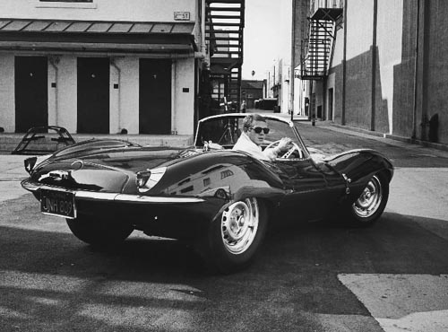 Steve McQueen in his sports car, 1963