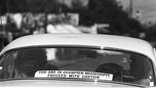 A sign in rear window of car in Philadelphia, Mississippi: