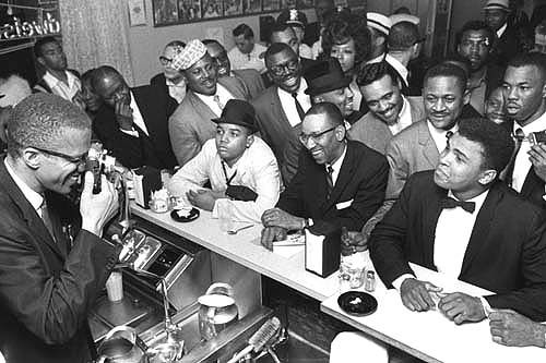 Black Muslim leader Malcolm X photographing Cassius Clay, Miami, 1964