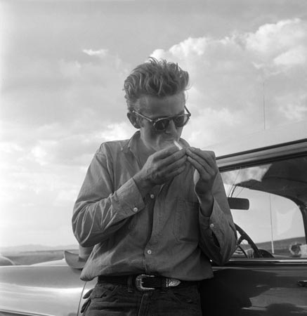 James Dean besides his car during the filming of 